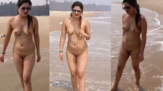 An Indian nude lady walks across the beach
